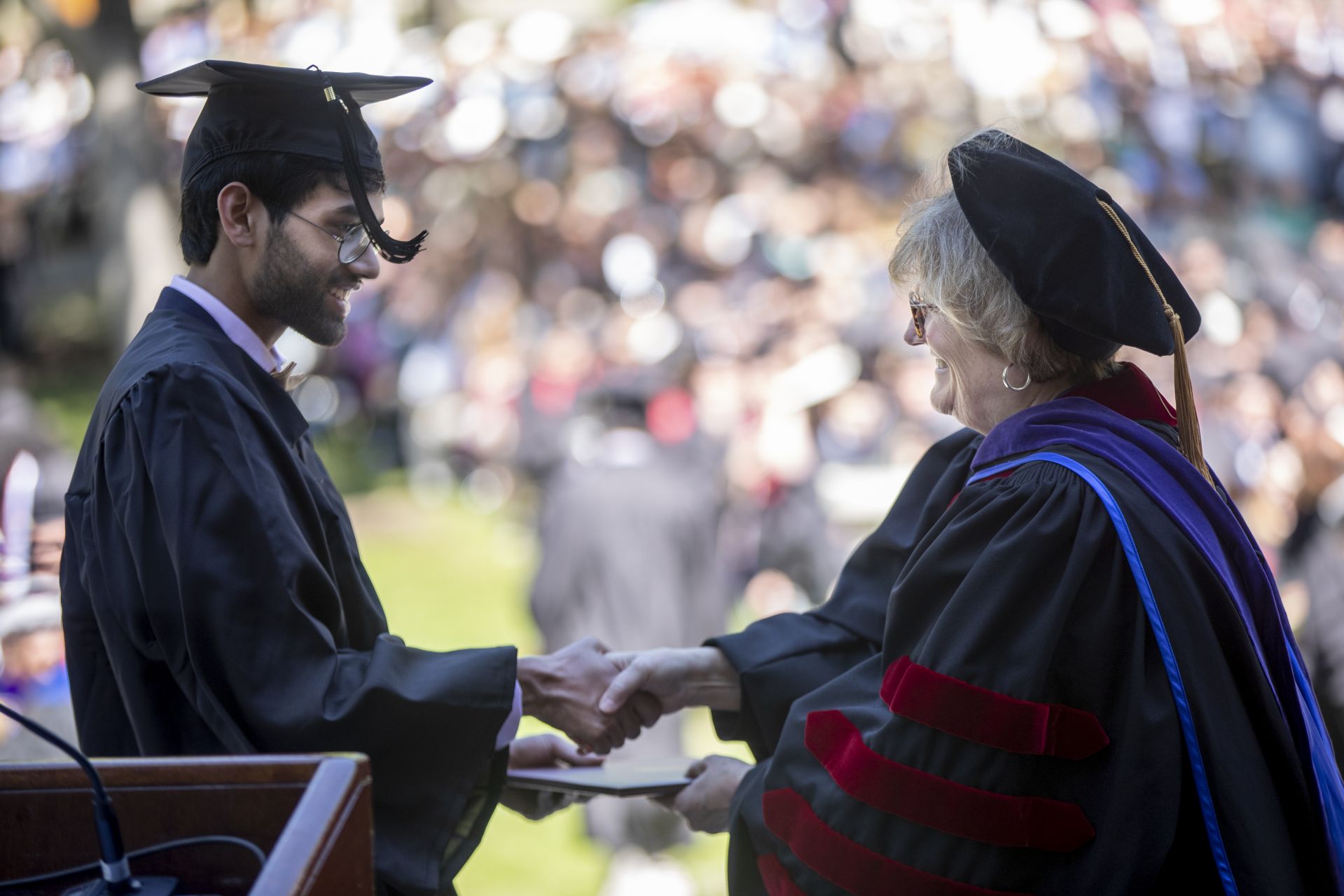 Rohan Bhat, a double major in philosophy and in classical and medieval studies, accepts his diploma from President Clayton Spencer. (Phyllis Graber Jensen/Bates College)