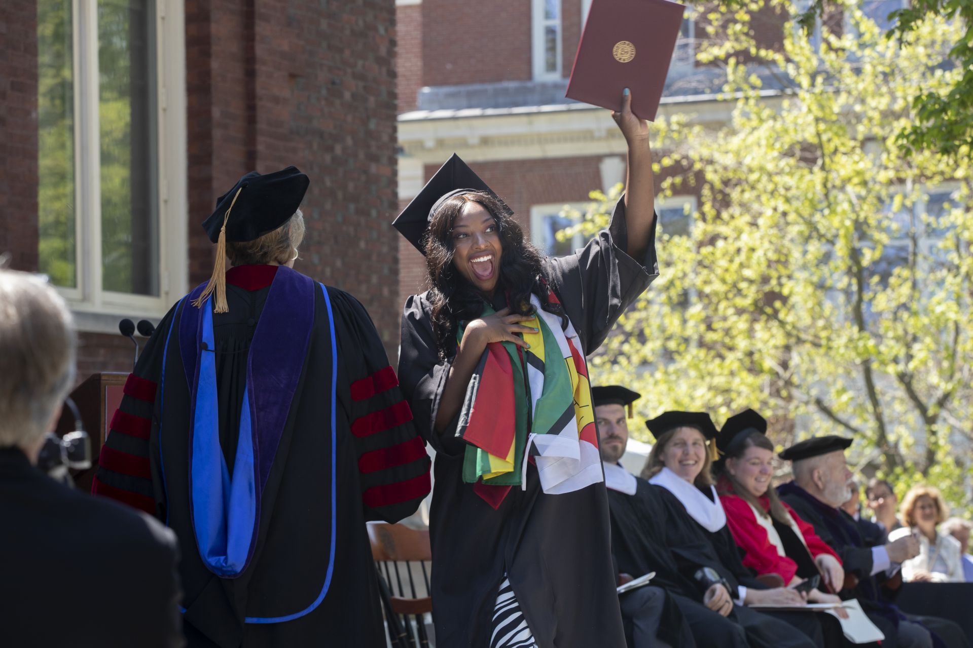 Kudzaiishe Irene Mapfunde, a psychology major, displays her diploma exuberantly. (Phyllis Graber Jensen/Bates College)