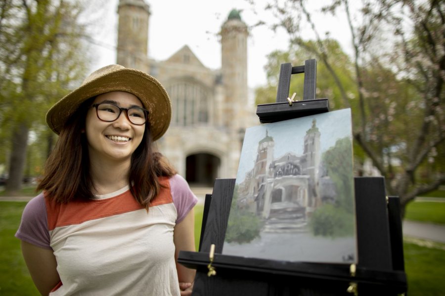 Laura Nguyen ’19 from Paoli, Pa., I am trying to live up my last few days here at Bates. I’ve wanted to do some oil painting for a really long time, and I figured today was the day. It was beautiful and sunny [when she started earlier in the morning]. Now it’s gotten a little bit cloudy. I feel like it’s symbolic, trying to wrap up my senior year.”What’s uppermost in your mind as you are preparing to leave?“I guess it’s trying to absorb all of Bates before you go and what it actually feels like to be a student here. Because I feel like when you come back to visit it’s a different experience…Painting is really relaxing for me. There’s something about painting the Bates buildings or memorializing that as an experience here at Bates that’s really important to me. It’s very relaxing to me, it’s something I like to do. I was in Penny Jones’ color theory class [during Short Term 2019]. It was really helpful. I’ve been in the artistic, painting mindset so I figured I’d do some other stuff too while I have the time”Russ Dillingham of the Sun Journal also had stopped by to photograph her.
