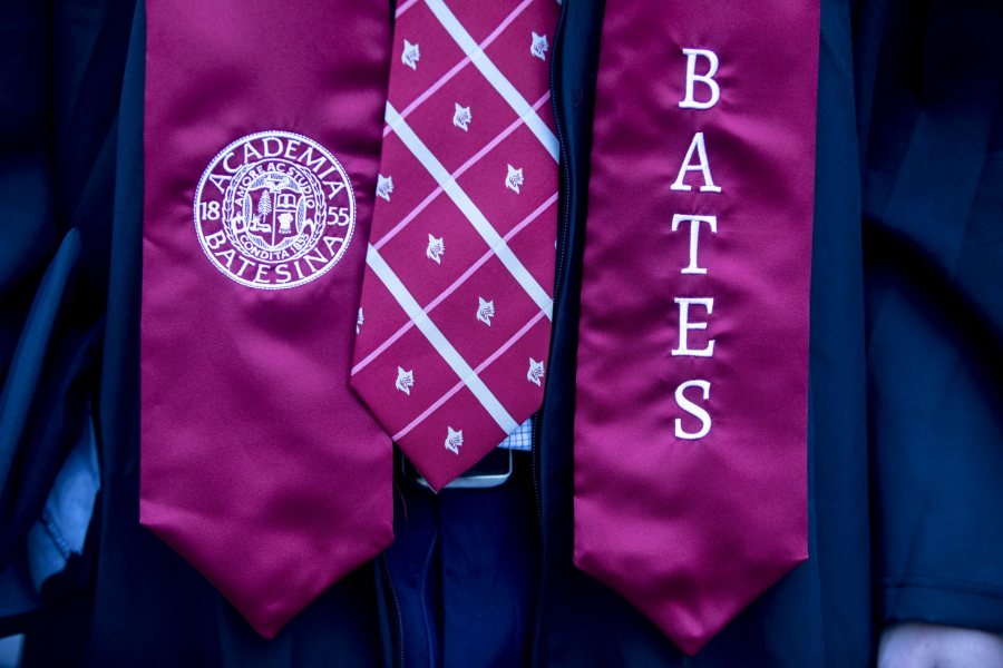 Bates College 2019 Commencement (the one hundred and fifty-third) on the Historic Quad, at which Travis Mills receives an Doctor of Humane Letter. Placing the collar on Mills is the college's mace bearer, Charles Franklin Phillips Professor of EconomicsMichael Murray.