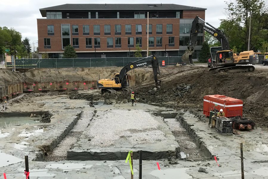 Shown on May 30, this U-shaped trench will become a site, six to eight feet deeper than the prevailing level, for wastewater collection tanks and the base of the elevator shaft. But first, sheet piles will shore up the walls of the trench, and only then it will be fully excavated. (Doug Hubley/Bates College)