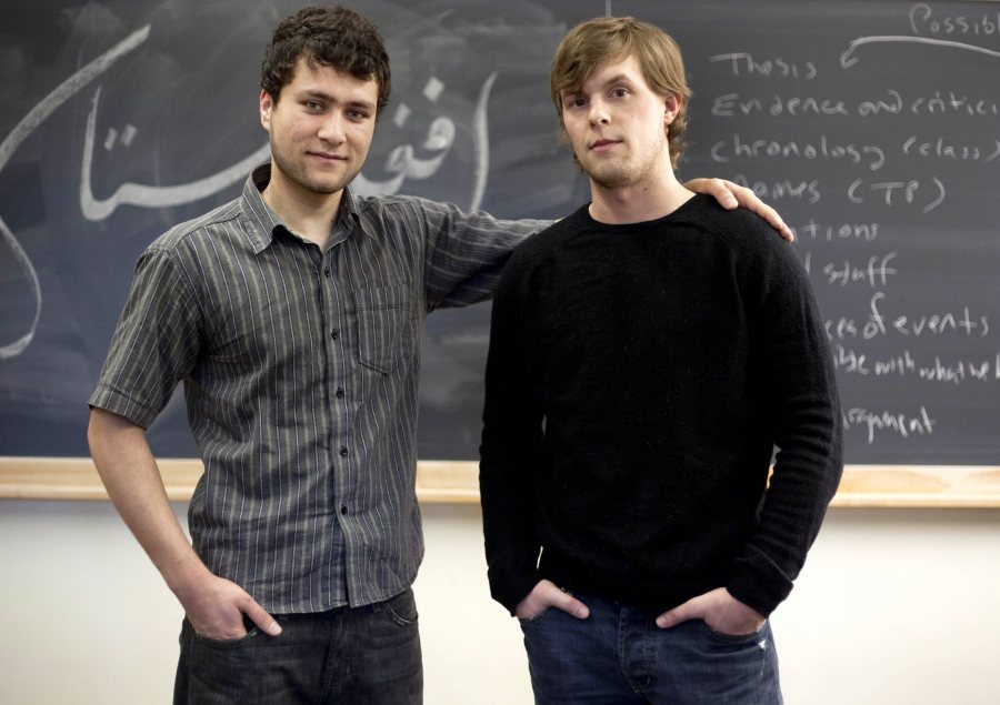 From left, friends Mohammed Mustafa Basij-Rasikh '12 and Jared Golden '11 pose together in a Pettengill history classroom. Mustafa has written the the longer word "Afghanistan" (at top) and the shorter word "peace" (directly between their necks) in Farsi on the blackboard behind them. In some frames, "peace" is obscured.