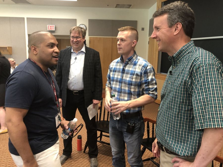 Darnell Morrow '14 greets Ben Cline '94 prior to the Reunion discussion on June 8. Both graduates of Washington and Lee Law School, the pair had met once before, when on opposite sides of a legal case. (Jay Burns/Bates College)