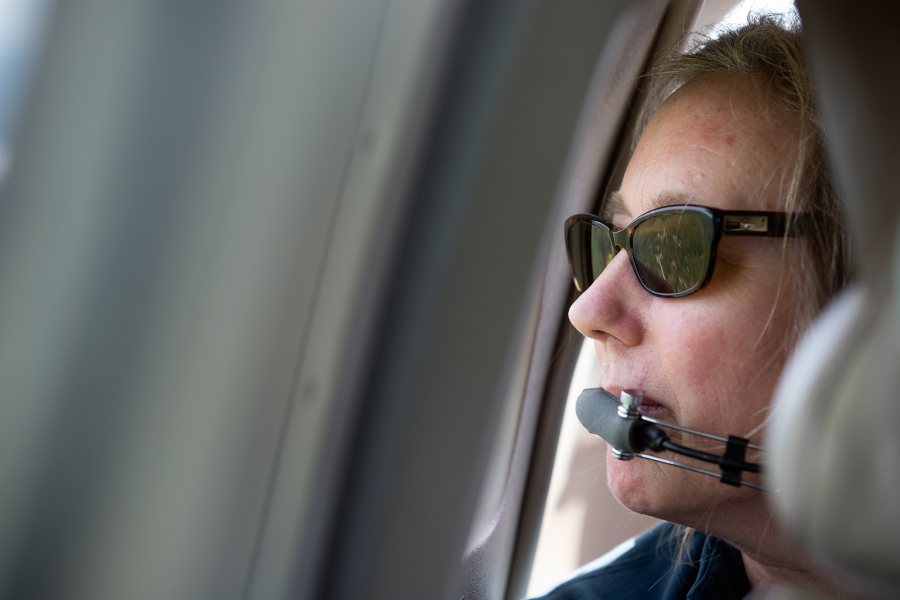 Director of Bates-Morse Mountain Conservation Area Laura Sewall observes Bates–Morse Mountain Conservation Area from a small plane in June 2019. (Brittney Lohmiller for Bates College)