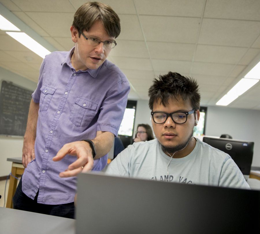 Seen in 2017, Assistant Professor of Physics Aleks Diamond-Stanic works with Jose Ruiz '19, who graduated in May with a physics degree. (Phyllis Graber Jensen/Bates College)