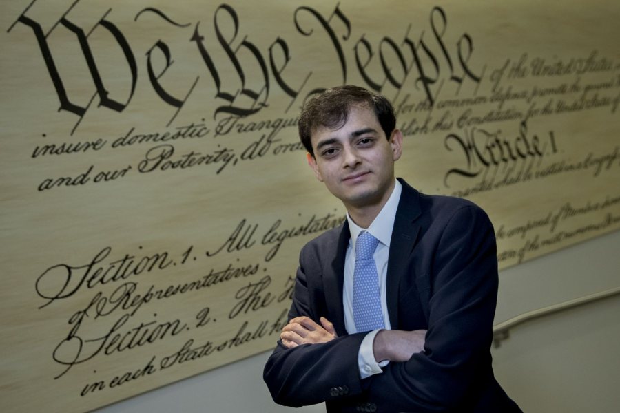 Javier "Andres" Carranza '21 of Santa Tecla, El Salvador, a research intern for the Center for Global Liberty and Prosperity at the Caro Institute, 1000 Massachusetts Avenue NW in Washington, D.C, photographed in a variety of locations in the Institute. He is a double major in economics and politics. Photographed in front of a facsimile of the U.S. Constitution He writes: "I focus on Latin America and cover a wide range of topics, from economic and human freedom, to taxation and migration. I basically assist my scholars, Juan Carlos Hidalgo and Ian Vasquez on any research they need. I mostly work on my cubicle at the intern room. The intern room is your average office-style set up, with around 35 cubicles with interns working on different stuff. However, the lobby and second floor has some pretty good spots for photographs. There is a cool library in there too." He writes: "I focus on Latin America and cover a wide range of topics, from economic and human freedom, to taxation and migration. I basically assist my scholars, Juan Carlos Hidalgo and Ian Vasquez on any research they need. I mostly work on my cubicle at the intern room. The intern room is your average office-style set up, with around 35 cubicles with interns working on different stuff. However, the lobby and second floor has some pretty good spots for photographs. There is a cool library in there too."