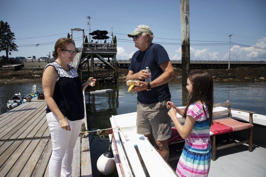 Kate McGowen Wing, '01, and her father Captain Jay McGowen, and daughter Tessa Wing, 8, of West Wind Lobster Tours in Bailey Island, interact in between tours on July 26, 2019.