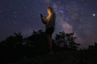 Ryan Mahoney ’20 Virginia Tech, Environmental Resources Management, working with Maine Coast Heritage Trust which placed me with KELT (Kennebec Estuary Land Trust), posses for a portrait using his photne to lit himself while watching the cosmos from on top of "The Rock" overlooking Meetinghouse Pond at The Coastal Center at Shortridge on July 29, 2019. He states:"As for my little biography, I was born and raised in Reston, Virginia and have lived there my whole life. Now I am going into my senior year at Virginia Tech majoring in 'Environmental Resources Management' and getting minors in 'Forestry' and Watershed Management'. This Summer, I got the opportunity to work with Maine Coast Heritage Trust which placed me with KELT (Kennebec Estuary Land Trsust). I wanted this internship because I knew it would give me experiences in the field of environmental conservation that I otherwise would not have been able to have. Staying at Shortridge this Summer has been an absolute blessing and I will forever cherish my time here forever.""Growing up, I always loved to look at the night sky and stars. When there was a meteor shower or celestial event, my parents would wake me up in the middle of the night and drive me and my siblings out to a field where we could see the sky with the least amount of light pollution possible. Last night at Shortridge was my first time seeing a truly clear night sky with no light pollution and it was absolutely breathtaking. Words cannot do justice for what I saw last night. Looking up, I could see the whole Milky Way, more stars than imaginable, and even space stations or satellites floating in the endless wonder. Standing up on that rock and looking at the intricacies of the universe flushed me with feelings of wonder, astonishment, and excitement. Those moments are the moments I chase in life and I hope to see a sky like that again sometime soon."