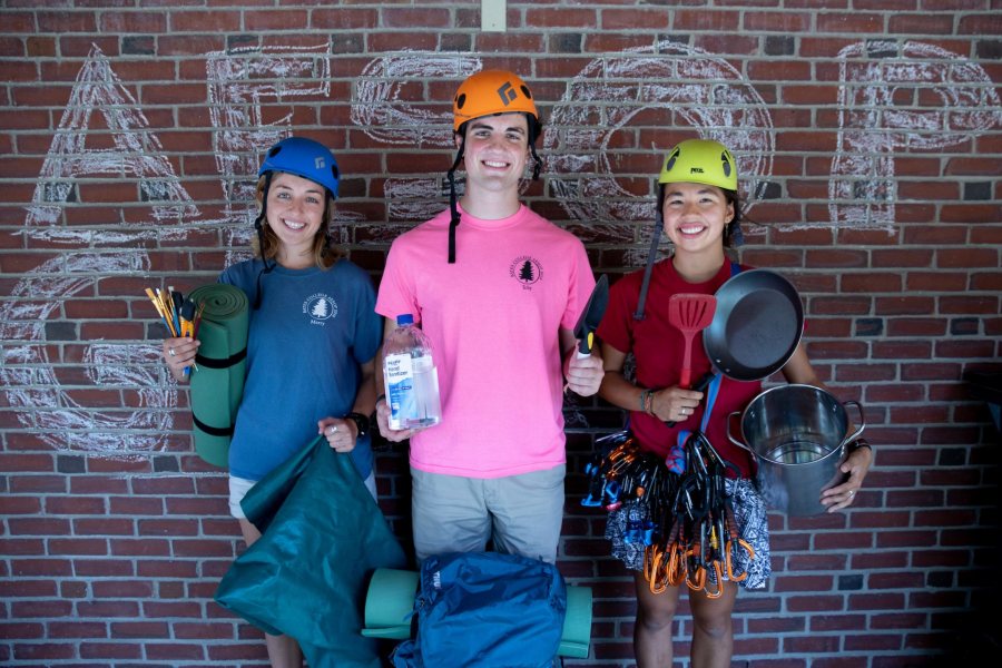 AESOP 2018-19 Coordinators, photographed in the AESOP equipment room, on the loading dock, and in Memorial Commons where they have assembled two boxes for each AESOP trip, one for food, the other for gear, on the day when all AESOP trip leaders will arrive to begin training for the upcoming trips for the Class of 2023. Peter Griffin '20 in pink shirt,, Grace Warder '20 in red shirt, and , Erni Whitaker '20 in blue shirt. Whitaker, Ernestine B ‘20 of San Luis Obispo, Calif., Griffin, Peter F ‘20 of Beverly, Mass. Warder, Grace Y ‘20 of New York City