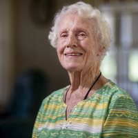 Dorothy Foster Kern '42 speaks with Bates Communications Office writer Emily McConville in the living room of her 64 Grandview Avenue home in Auburn, Maine. McConville brought some Bates memorabilia for Kern to inspect.Kern will turn 100 on Sept. 23, 2019. She retired in 1980 after 20 years of being the librarian at Edward Little High School.