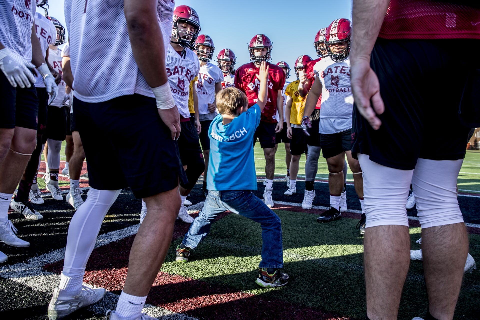 During its Sept. 19, 2019 practice, honorary team captain, Brayden Austin, 6, of Sabbatus, joins the team on the field. (Phyllis Graber Jensen/Bates College)