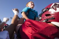 During its Sept. 19, 2019 practice, honorary team captain, Brayden Austin, 6, of Sabbatus, joins the team on the field.