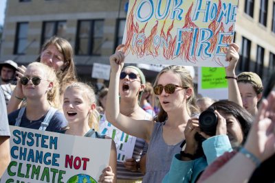 Left, Tamsin Stringer '22 of Bloomington, Ind., (system change not climate change) and Reilly Dwight '22 of Sebastopol, Calif. (our home is on fire) and in green jacket and black shirt on right, Ashka Jhaveri '22 of Chappaqua, N.Y.“I can't believe I'm even having to protest this.”.— Muskan Verma '21 of Shimla, India, shares the frustration of inaction on global climate change after she addressed a crowd of at least 2,000 at Portland City Hall gathered for the student-mobilized Global Climate Strike, ahead of the opening of the United Nations General Assembly and the Climate Action Summit on Sept. 23..“I'm not from this country,” she said. “But that shouldn't matter. This is affecting us all. And whether we like it or not, we have to take action.”.A representative of the Sunrise Movement, a youth-led movement for climate-change action, Verma is a double major in theater and in rhetoric, film, and screen studies. She joined a large contingent of Bates students and several faculty who attended the event, organized, in part, by the Bates Environmental Coalition..