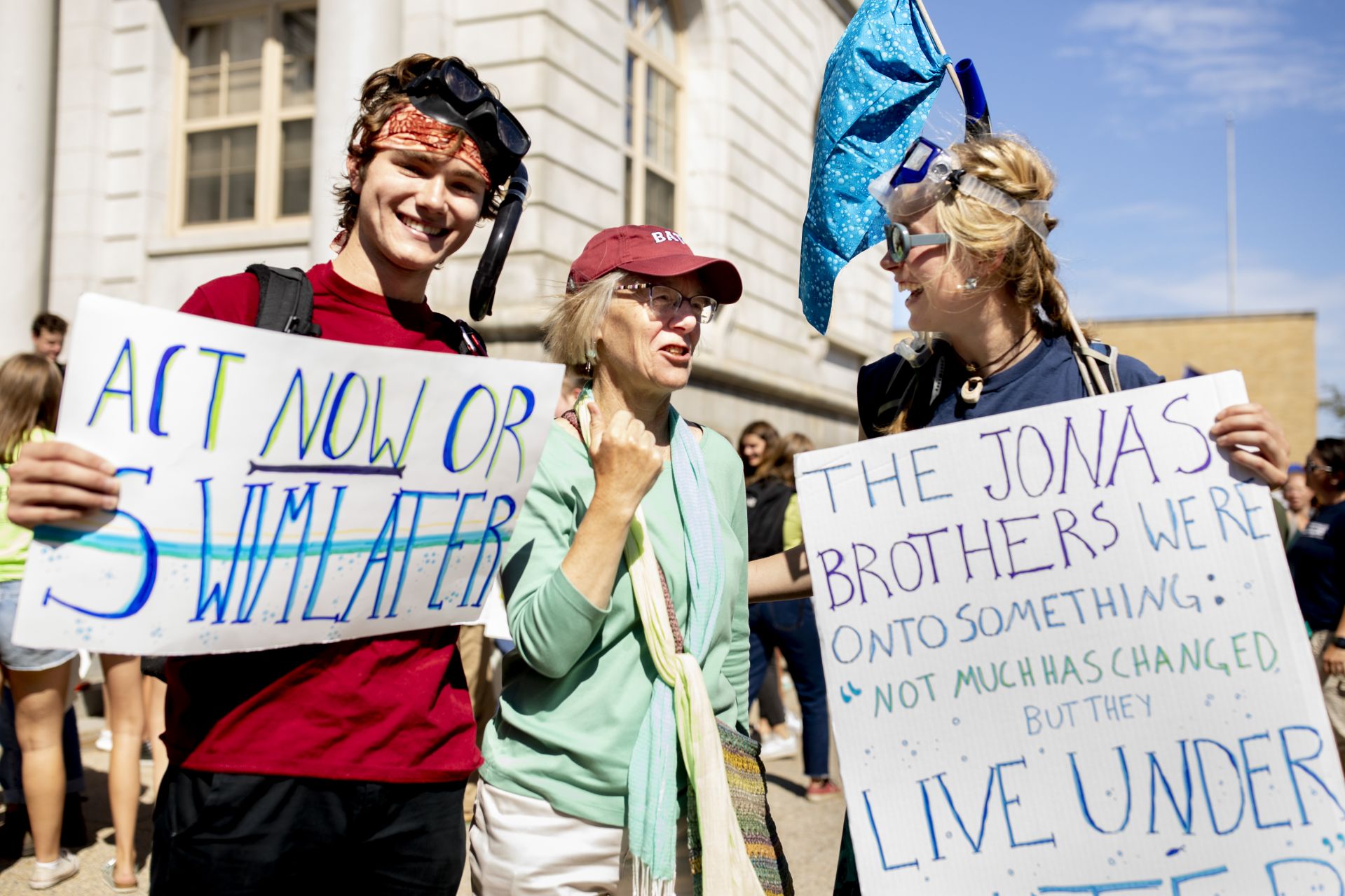 Costlow connects with philosophy major Jasper Beardslee '22 (left) of Miami and geology major Essie Martin '21 of Newcastle, Maine, after the rally. (Phyllis Graber Jensen/Bates College)