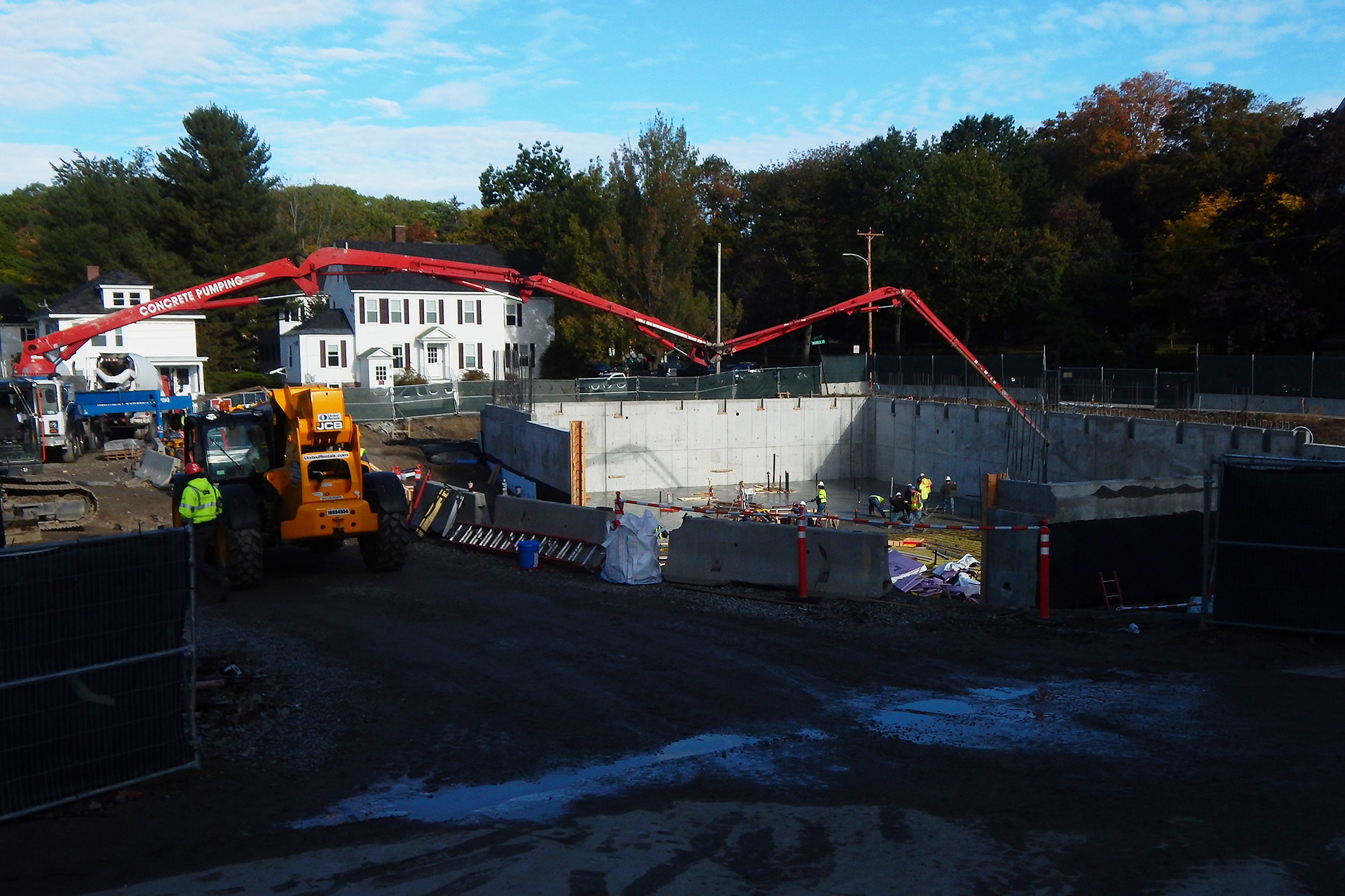 The concrete basement floor was placed in the Bonney Science Center on Oct. 3. The pumper at left is sending concrete through the boom to the furthermost corner of the basement. (Doug Hubley/Bates College)