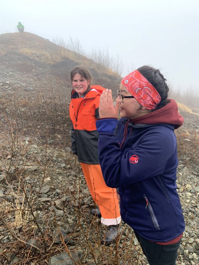 Anna Truman-Wyss ’21 (left) and Skylar Wassillie, a student from Togiak School, walk together during the annual climb up Two Hill near the village. (Courtesy Kristen Barnett)