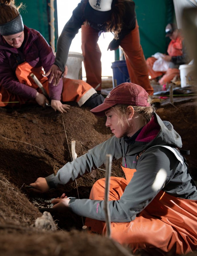 Trowel in hand, Hanna Webster ’22 excavates soil at the Old Togiak site on May 15. (Tim Leach ’99 for Bates College)