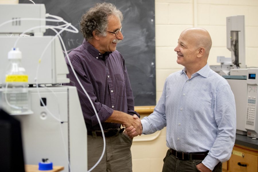 Thomas Wenzel and Jim Weissman ’84 reconnect in a laboratory in Dana Chemistry Hall in September. Weissman, a chemistry major who was mentored by Wenzel and now chief operating officer at Dicerna Pharmaceuticals, established with his wife an endowed fund in Wenzel’s name. (Phyllis Graber Jensen/Bates College)