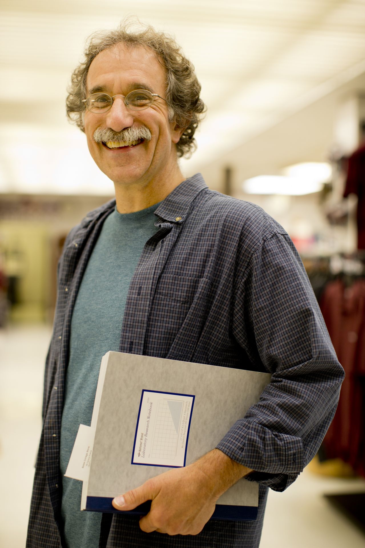 In his 33rd year at Bates, Tom Wenzel, Charles A. Dana Professor of Chemistry, stopped by the Bates College Store to buy a couple of laboratory notebooks for two seniors who will  do research with him this academic year. "We do research on trying to distinguish molecules that have the property of your left and right hands, that they're mirror images of each other," he says. He has been doing research on this area for almost 25 years. What's in it for him? He cites two things. One is that many pharmaceutical compounds have this property, and it's critically important to be able to distinguish them from each other. So the work we do has great significance to drug development. The other part is just the fantastic educational experience for the students working on these research projects because of their independent nature."