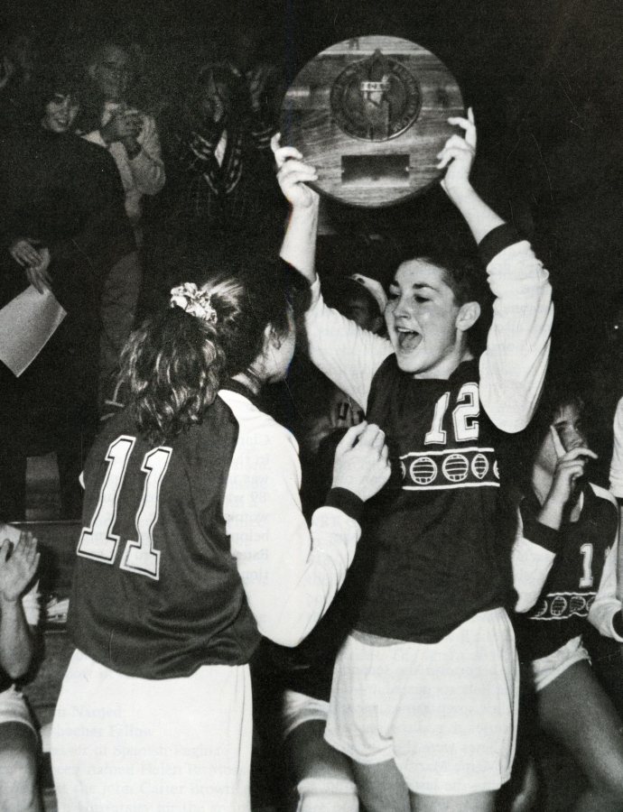 Co-captains Michele Feroah (right) and Cathy Meoni celebrate Bates' victory in the 1989 ECAC championship match, capping a 36-0 season. (Bates Communications)