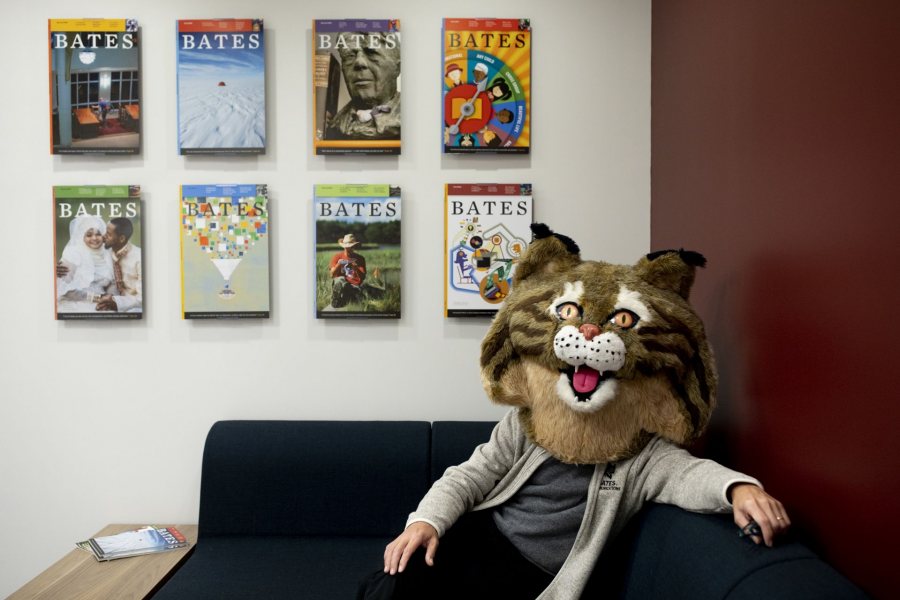 Jay Burns relaxes in the Bates Communications Office greeting area at the end of the day on Friday, Oct. 18, 2019. He's wearing the top half of the Bates Bobcat costume.