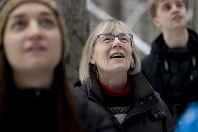 From left, Wilder Geier ‘22, Lars Schuster ’20, and Julian Cook ’20 take a look at a pileated woodpecker in Lewiston’s Thorncrag Bird Sanctuary..Nick Lund of Maine Audubon @maineaudubon spotted the bird as he led Clark A. Griffith Professor of Environmental Studies Jane Costlow and students in her “Living With Animals” course on a midday birding excursion during their last class session.