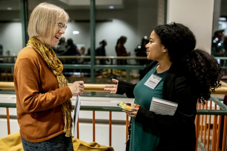 Costlow greets Visiting Assistant Professor of Africana Cassandra Shepard after the Otis talk in November. They have discovered their mutual research and teaching interests in disaster. Shepard teaches about Katrina, Costlow about Chernobyl. (Phyllis Graber Jensen/Bates College)
