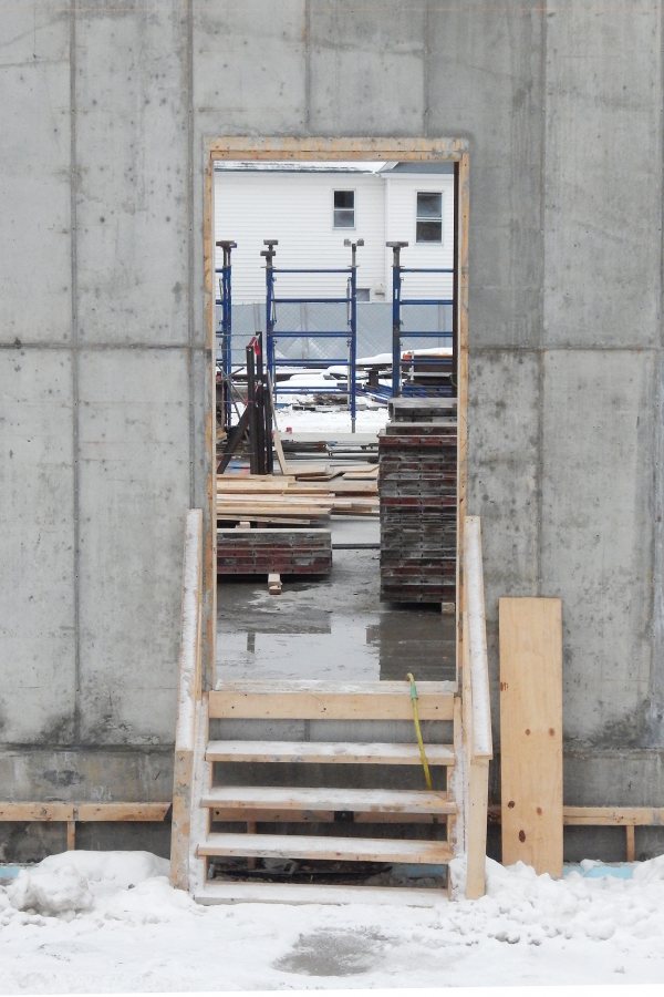 A view into the Bonney Science Center from Campus Avenue on Jan. 6, 2020. The house framed by the doorway, 137 Nichols St., was torn down the following day. (Doug Hubley/Bates College)