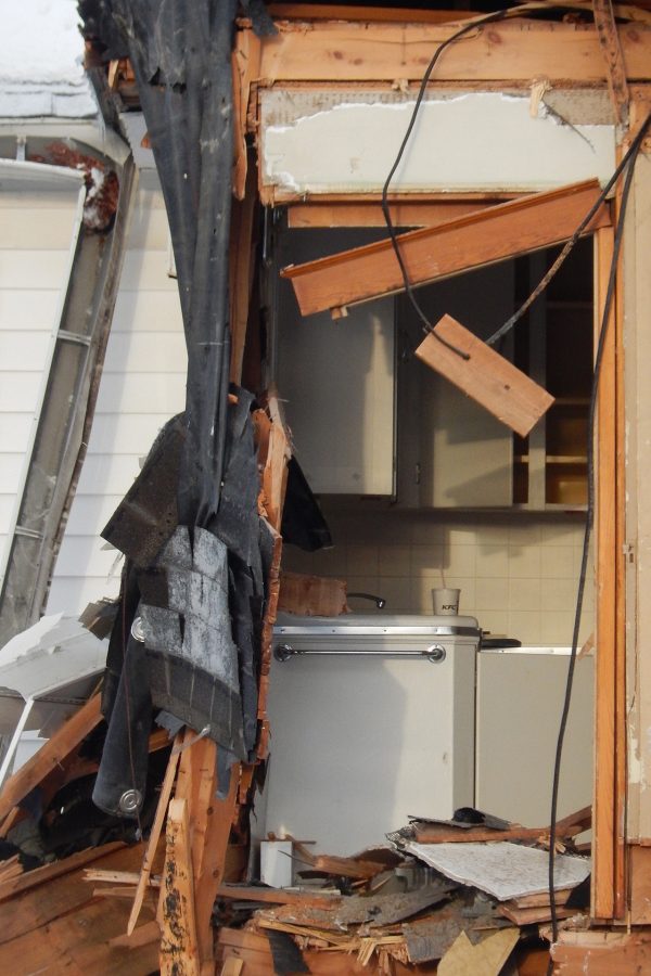 The excavator's claw unveiled a second-story kitchen sink during the razing of 137 Nichols St. (Doug Hubley/Bates College)