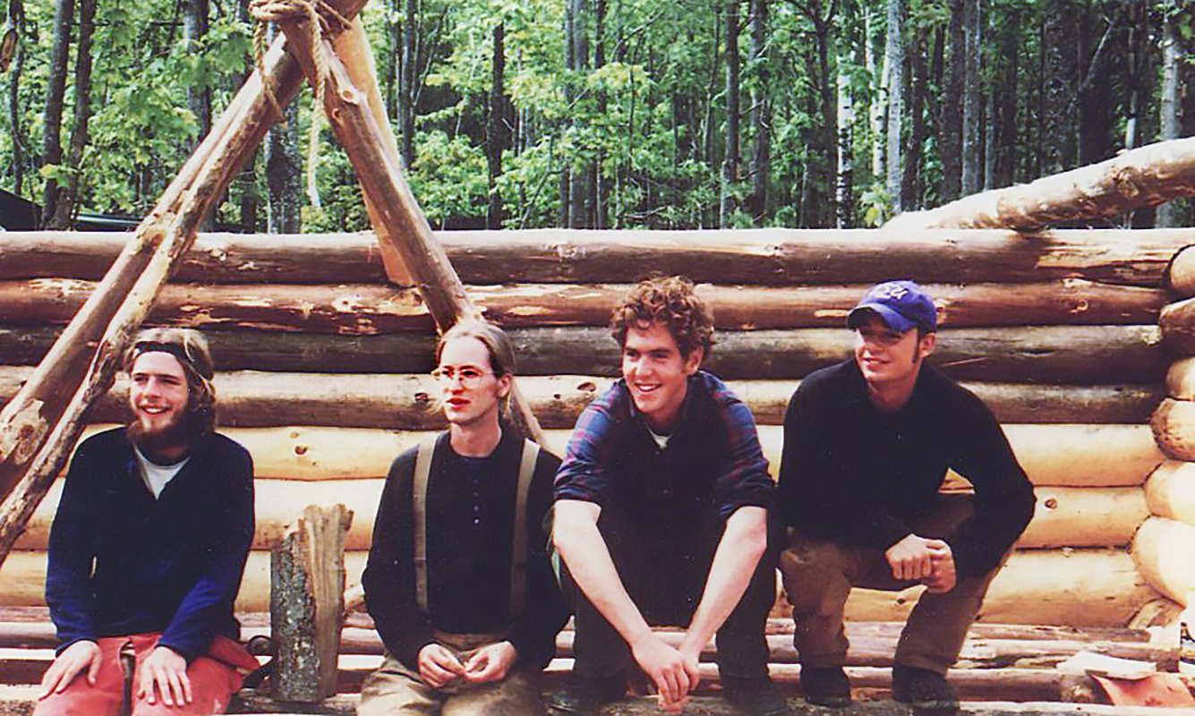 From left, 1999 classmates Ben Ayers, Brad Morse, Erik Thomson, and John MacKay pause during construction of the Bates Outing Club lean-to in May 1999.(Judy Marden '66)