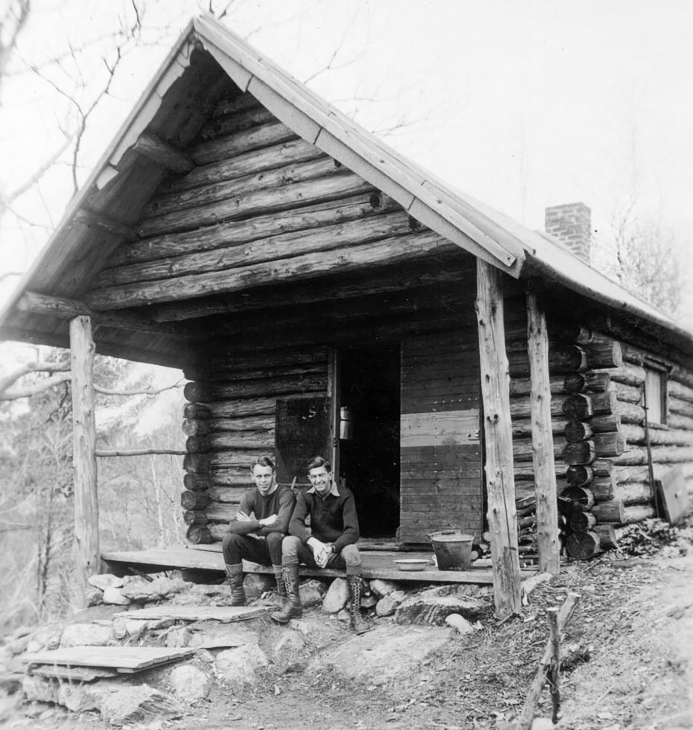 Circa 1934, two students pose outside the Bates Outing Club cabin on Sabattus Mountain in nearby Wales. (Muskie Archives and Special Collections Library)