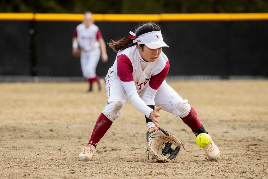 Kennedy Ishii ’22 grabs a low ball as Bates defeats Colby 4-0 in the first home game of a double header on April 6, 2019. (Phyllis Graber Jensen/Bates College)