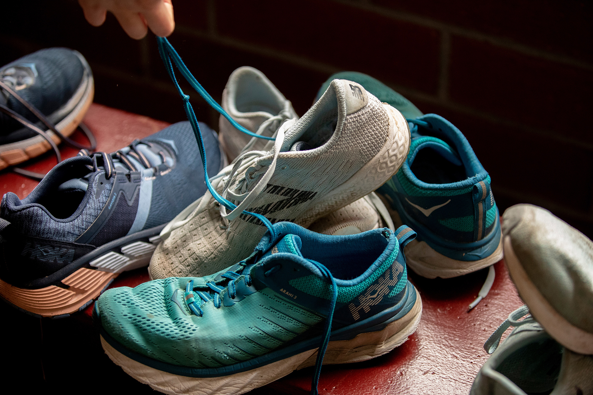 Caroline "Carly" Harris '22 of Orinda, Calif.,with worn-out shoes, examples of what she will be recycling in the lobby of Merrill Gymnasium.