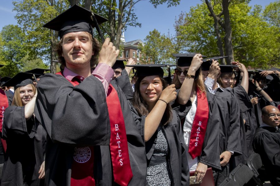 Bates College 2019 Commencement (the one hundred and fifty-third) on the Historic Quad, at which Travis Mills receives an Doctor of Humane Letter. Placing the collar on Mills is the college's mace bearer, Charles Franklin Phillips Professor of EconomicsMichael Murray.