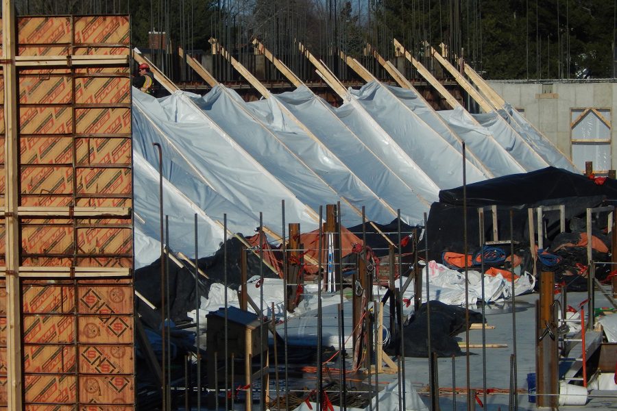 Seen from a third-floor lounge in Chu Hall on Feb. 28, 2020, the second floor of the Bonney center is surrounded by Symons concrete-form panels and rebar, and cluttered with poly sheeting, concrete-insulating blankets, tools, safety harnesses and much more. (Doug Hubley/Bates College)