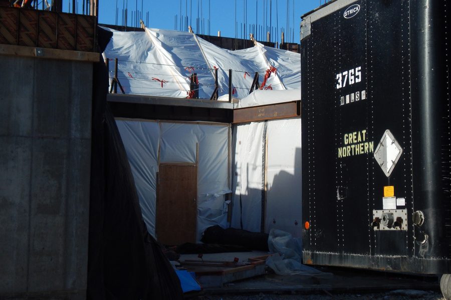 Also known as the "Notch," here's the north entrance to the Bonney building on Feb. 28, 2020. The poly sheeting above helps keep wall concrete at a good temperature for curing, while the sheeting below helps shield construction workers from the cold and wind. (Doug Hubley/Bates College)