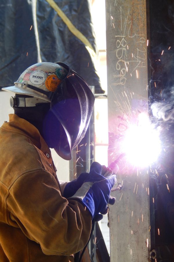 A welder for Precision Steel works on a seam on the Bonney center's second floor. (Doug Hubley/Bates College)