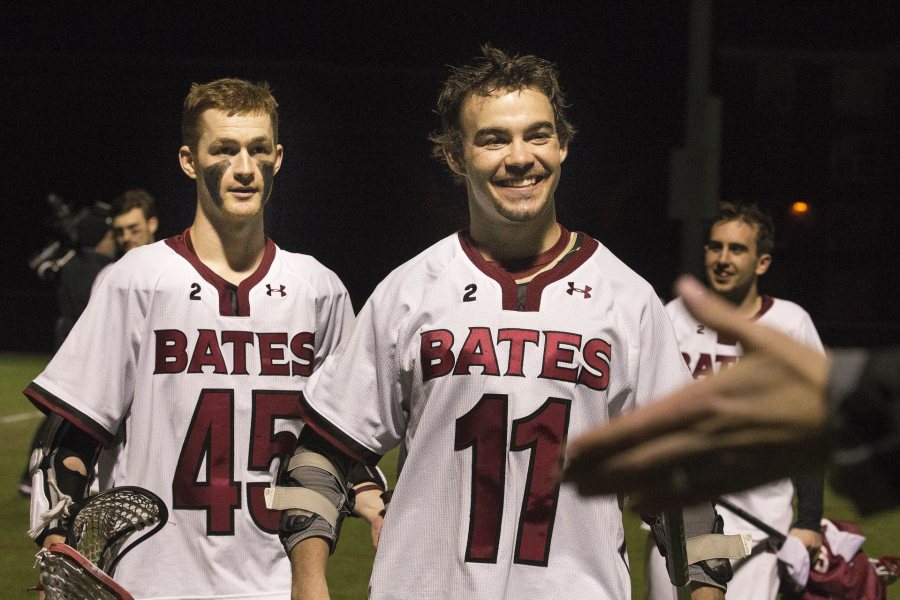 Jack Allard '16 (left) and classmate Charlie Hildebrand celebrate a big Bates lacrosse win over Tufts in April 2016. (Phyllis Graber Jensen/Bates College)