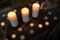 Multifaith Chaplain Brittany Longsdorf lights a communal candle during a 9/11 Moment of Remembrance at the Chapel Monday morning.