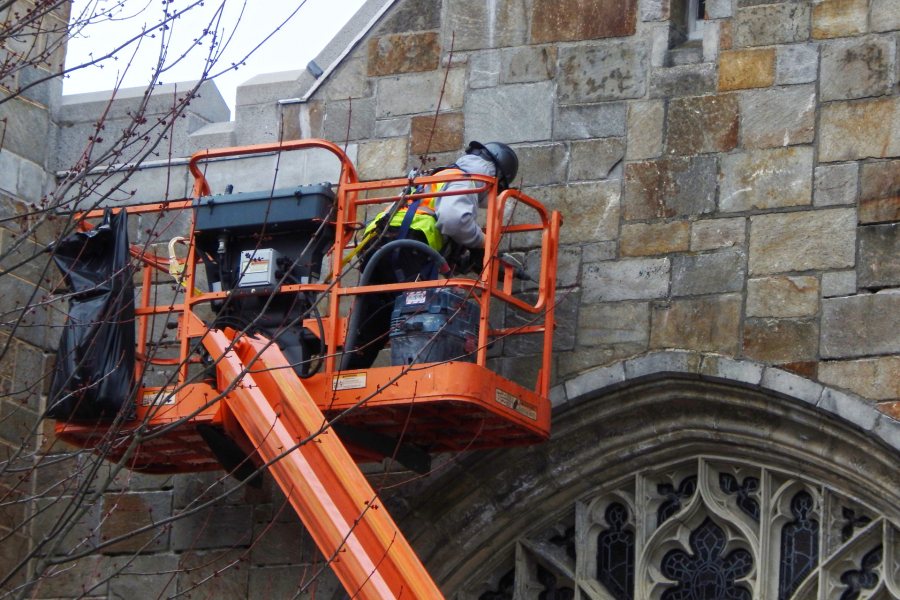 With masonry repairs  complete on the east and west exterior walls of the Gomes Chapel, the emphasis has shifted to the north (shown) and south walls. (Doug Hubley/Bates College)