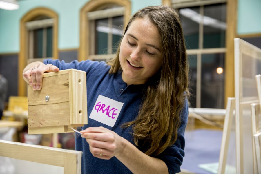 Awarded this year for community engagement, Grace Ellrodt takes part in a 2018 Window Dressers workshop in Lewiston. Window Dressers is a Maine nonprofit that brings volunteers together to produce low-cost insulating window inserts that help retain heat in homes. (Phyllis Graber Jensen/Bates College)