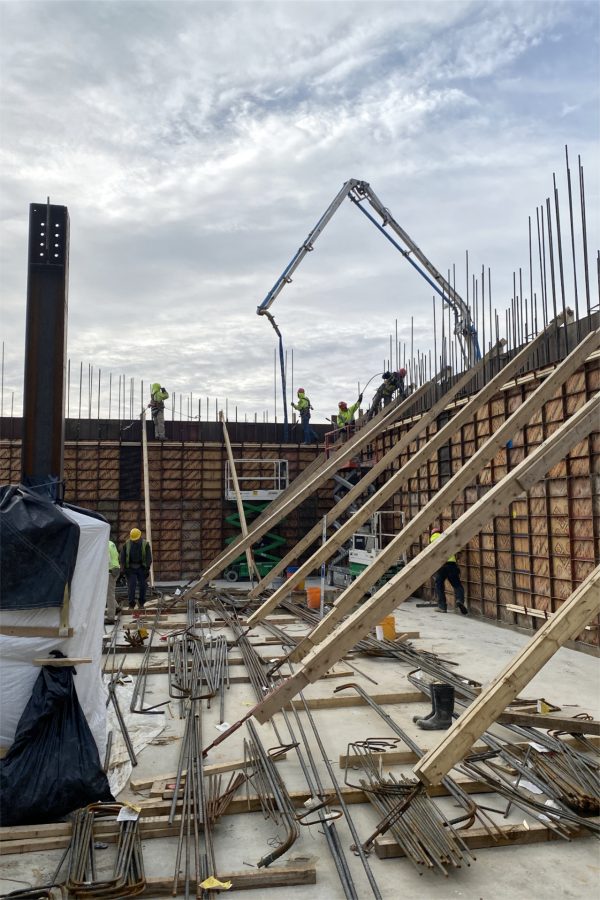 The concrete pump fills a section of third-level wall on April 24. (Geoff Swift/Bates College)