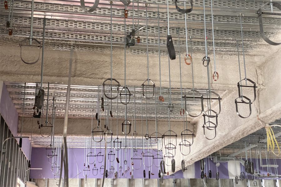 Hangers for pipes, conduits, ducts, etc. dangle from second-floor decking. (Geoff Swift/Bates College)