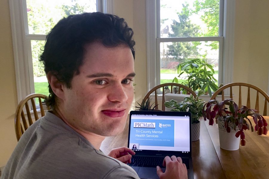 Jason Canaday 20, a student in Adriana Salerno's “PIC Math: Topics in Industrial Mathematics" course, at home in Wellesley, Mass., where he has been doing work for the course on his laptop in his bedroom and the family kitchen.