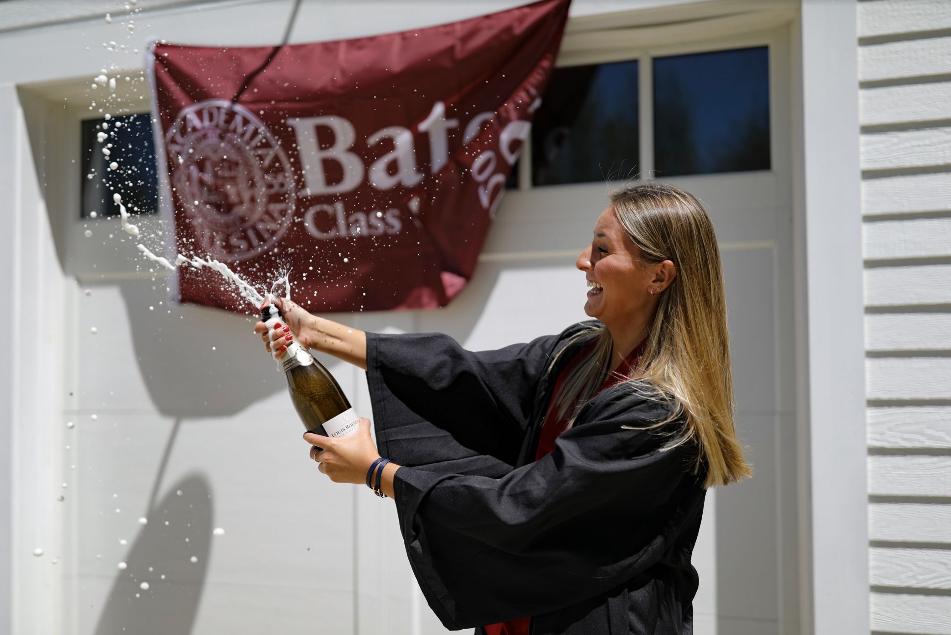 Scenes from Commencement Day, May 31, 2020. Anna Glass '20 of Wilton, Maine, celebrates at home with her parents, Marc and Wendy Glass .@berglicht