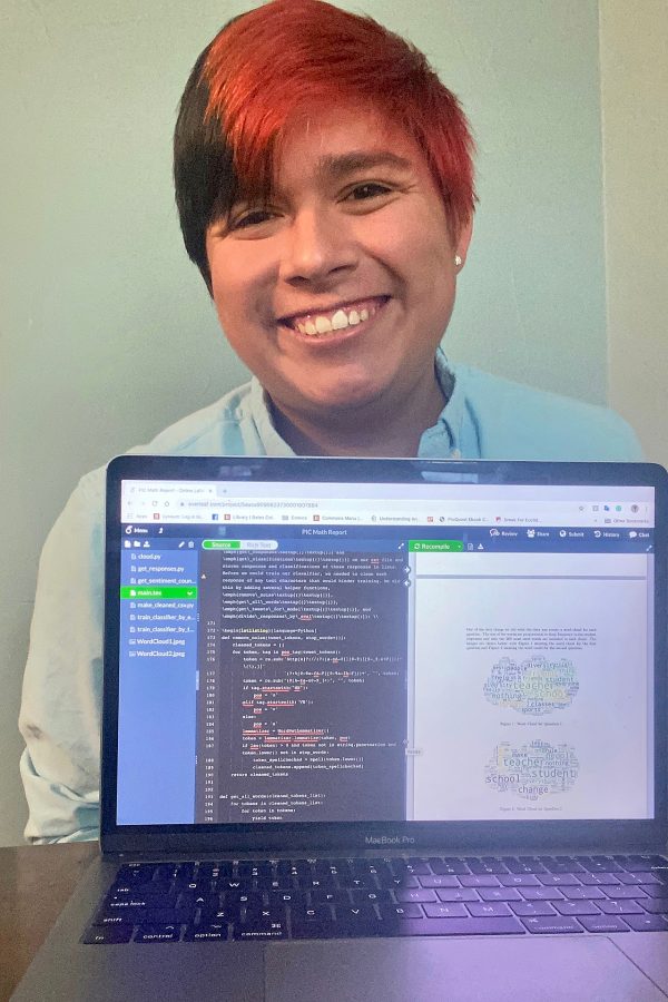 Jesus Carrera ’20, a math major from Waco, Texas, poses with his laptop open to an app called Overleaf and his team's final presentation to the Lewiston public schools.