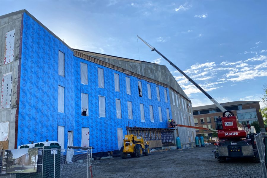 Gray turns to blue: "Blueskin" weatherproofing application has begun. Bricks will follow. Note the opening for the building entrance at center: The wall above it functions as a so-called vierendeel truss. (Geoff Swift/Bates College)