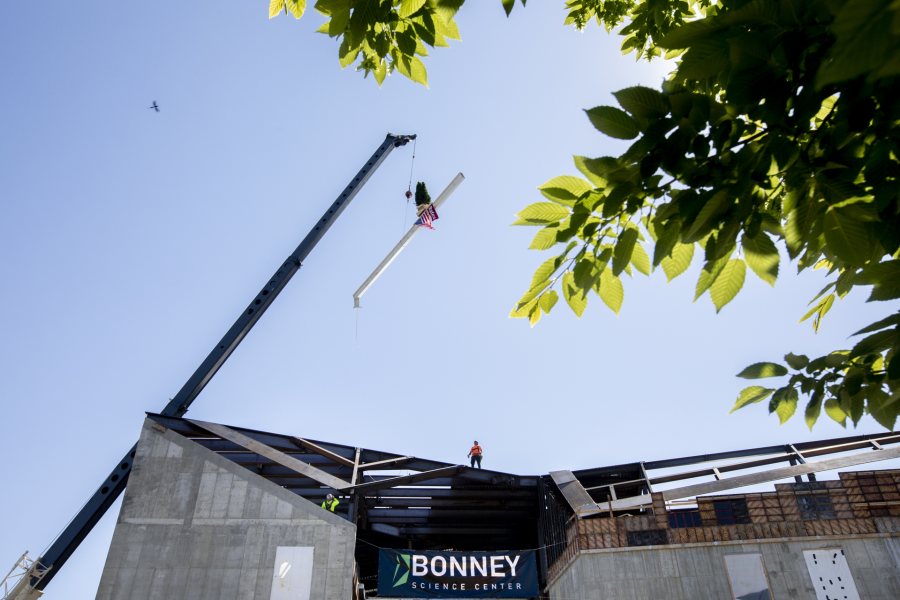 Images from the topping off event on May 16, 2020, at the Bonney Science Center, featuring the final major piece of structural steel being installed on the building. In keeping with tradition, a small spruce tree was attached to the beam fluttered plus a Bates banner and the American flag. The beam has the signatures of Bates participants and members of the Consigli construction crew.Participants: Michael W. Bonney ’80, P’09, P’12, P’15Alison Grott Bonney ’80, P’09, P’12, P’15Sarah R. Pearson ’75, Vice President for College AdvancementA. Clayton Spencer, PresidentChris Streifel, Facilities Services Project ManagerGeoff Swift, Vice President for Finance and Administration and TreasurerPam Wichroski, Director of Capital Planning and ConstructionDave Thomas, Consigli Construction Michael Hinchcliffe, Payette Architecture Firm Bob Schaeffner, Payette Architecture Firm