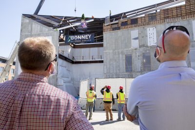 Images from the topping off event on May 16, 2020, at the Bonney Science Center, featuring the final major piece of structural steel being installed on the building. In keeping with tradition, a small spruce tree was attached to the beam fluttered plus a Bates banner and the American flag. The beam has the signatures of Bates participants and members of the Consigli construction crew.Participants: Michael W. Bonney ’80, P’09, P’12, P’15Alison Grott Bonney ’80, P’09, P’12, P’15Sarah R. Pearson ’75, Vice President for College AdvancementA. Clayton Spencer, PresidentChris Streifel, Facilities Services Project ManagerGeoff Swift, Vice President for Finance and Administration and TreasurerPam Wichroski, Director of Capital Planning and ConstructionDave Thomas, Consigli Construction Michael Hinchcliffe, Payette Architecture Firm Bob Schaeffner, Payette Architecture Firm