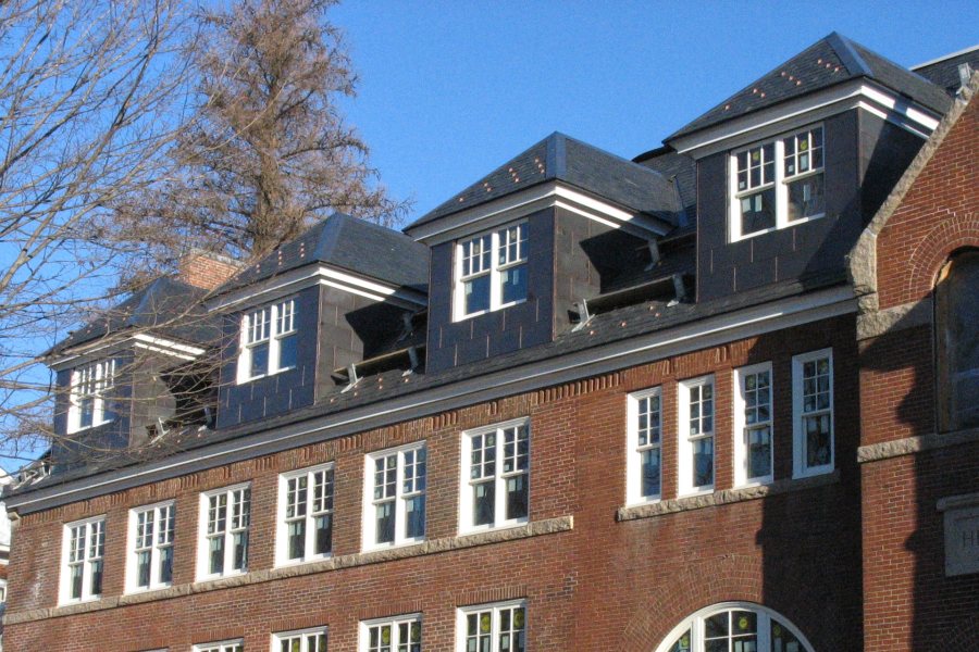 This January 2011 image shows Revere Copper's "Continental Bronze" cladding newly installed on the roof and dormers of Hedge Hall. (Doug Hubley/Bates College)